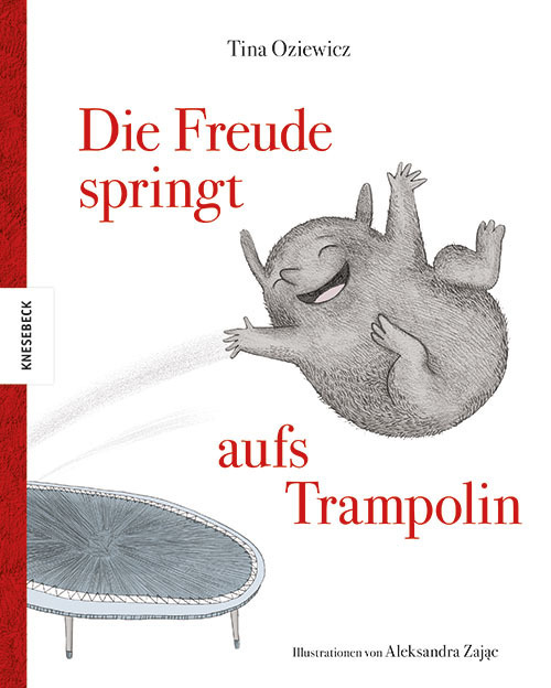 Ein graues lachendes, gezeichnetes Tierchen springt auf einem Trampolin und wirft die Arme in die Luft